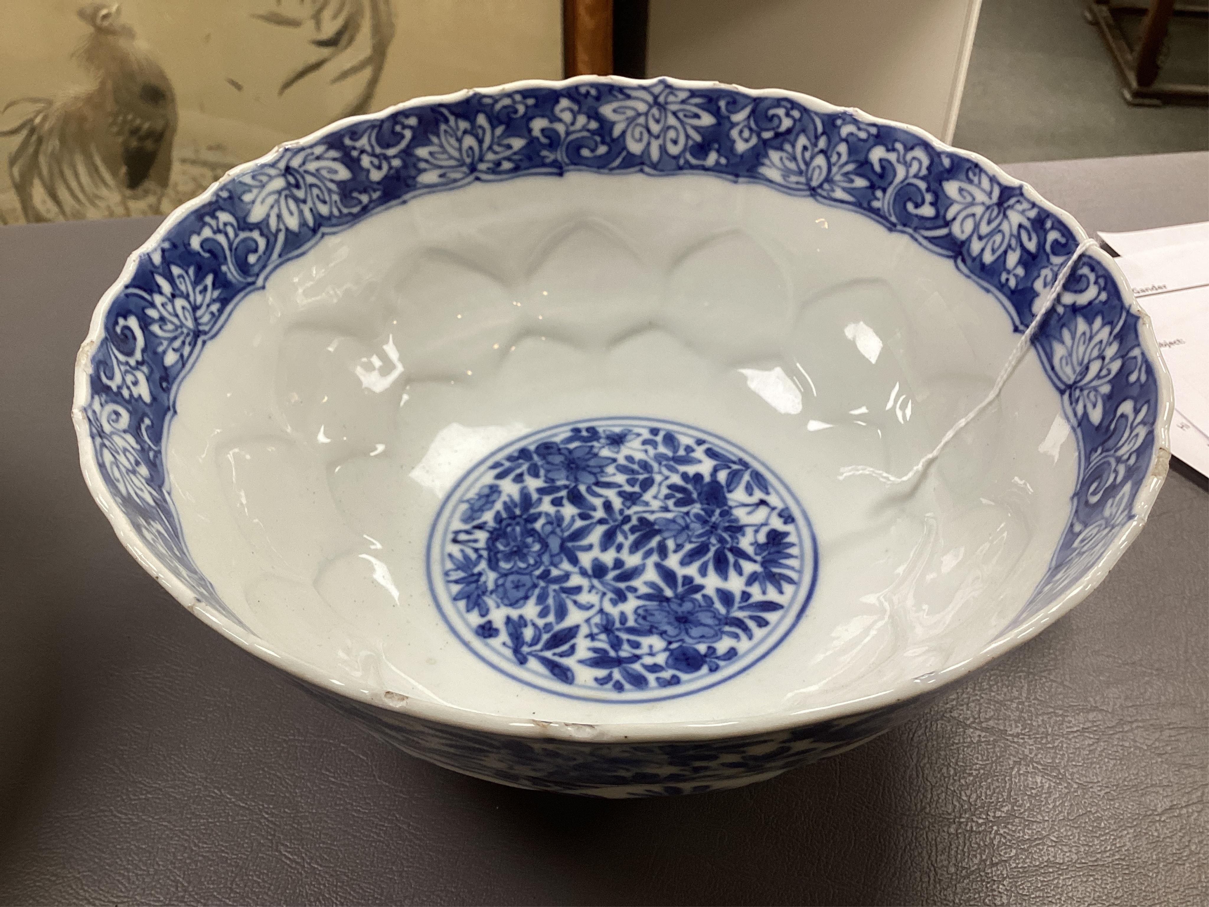 A near pair of Chinese blue and white lotus flower moulded bowls, Kangxi period